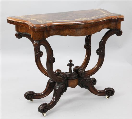 A Victorian marquetry inlaid walnut card table, W.3ft D.1ft 6in. H.2ft 5in.